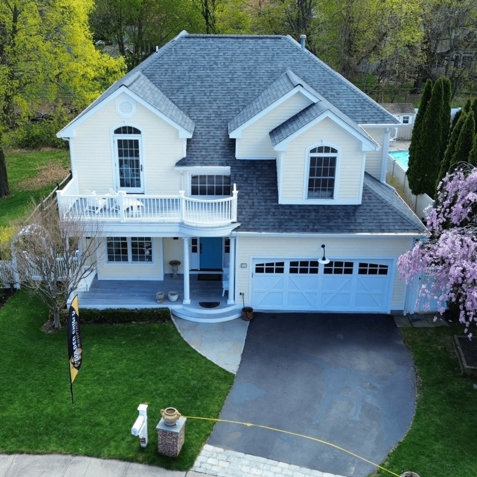 Front view of a completed roof replacement on a light-colored home in Connecticut.